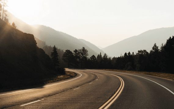 Blacktop road leading into the mountains